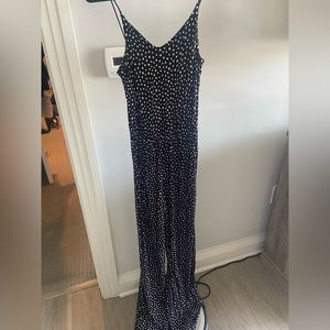 Black jumpsuit with white polka dots
